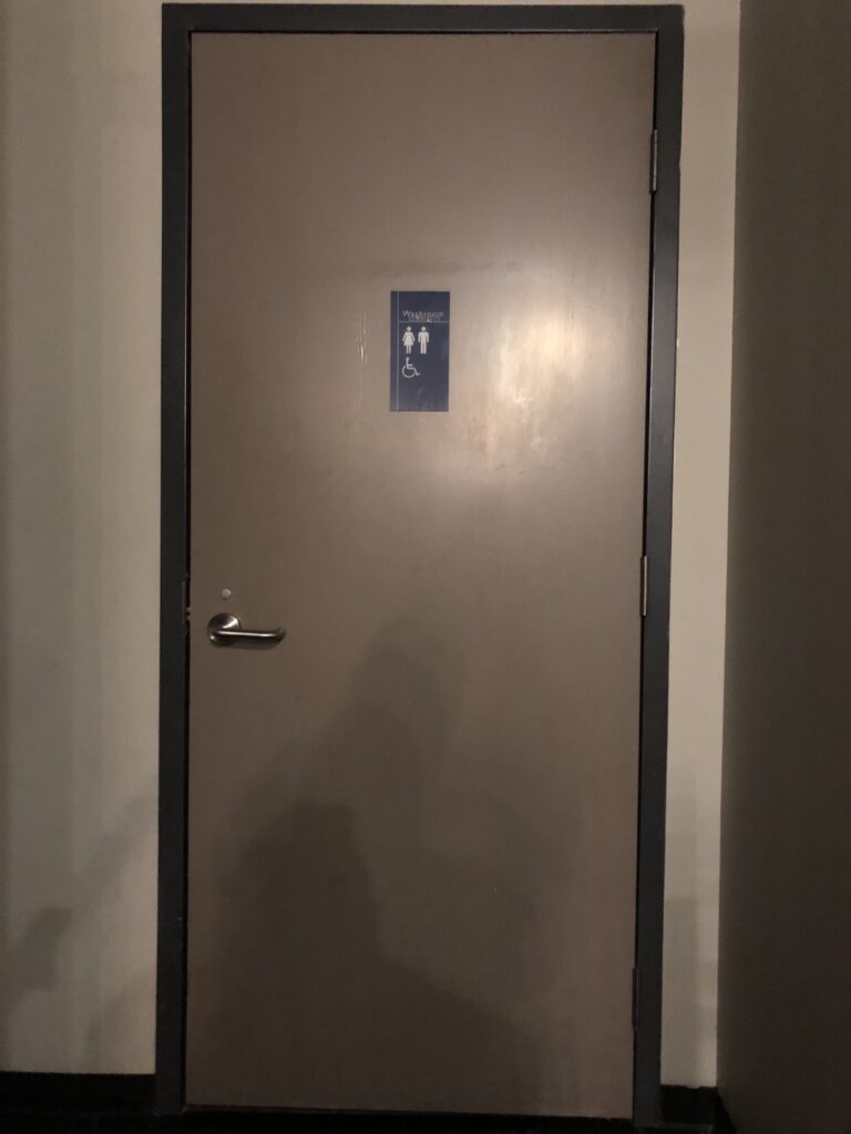 A door with a sign that indicates an accessible washroom.