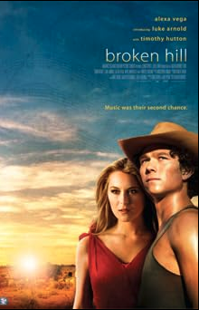 Poster of the film representing a white woman and a white man looking in front of them. There is a sunset in the background.