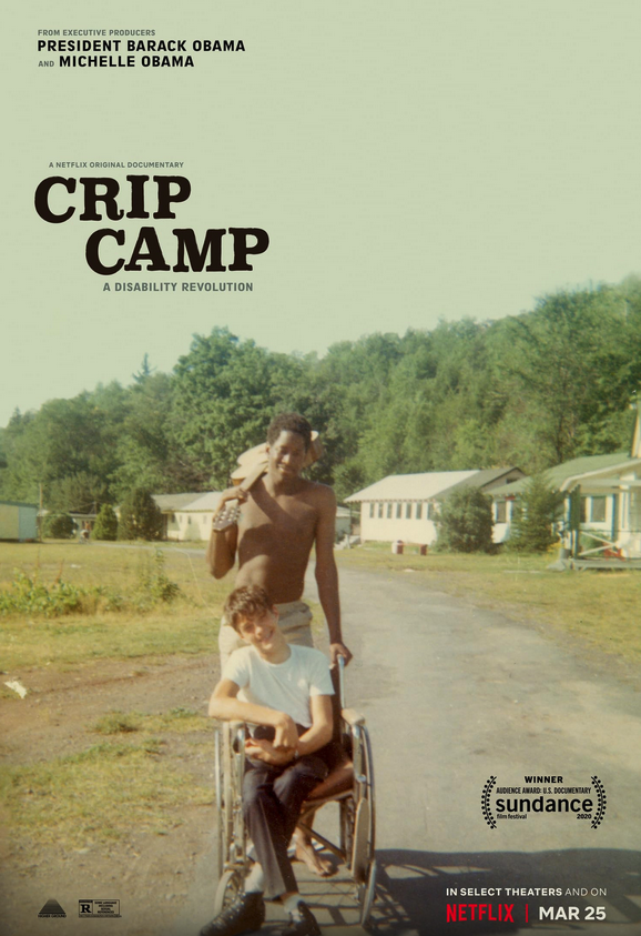 Poster of the movie representing a picture of a young bare-chested black man standing with a guitar on his shoulder, holding one of the handles of the wheelchair in which a white young man with a white t-shirt is sitting. They are surrounded by wooden barracks and trees.