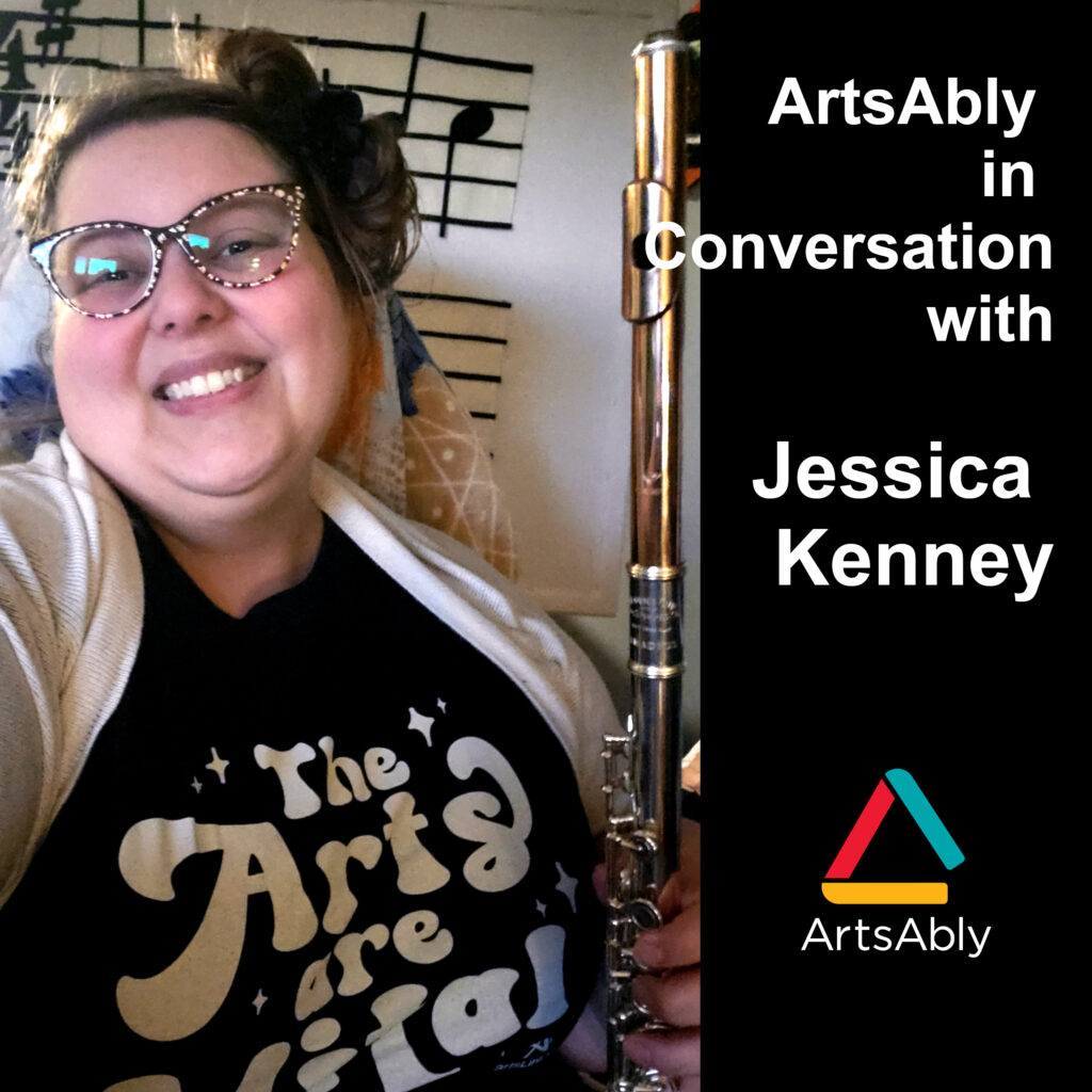 A non-binary, white person with black and pink glasses and blond short hair, wearing a black t-shirt and a white cardigan, and holding a flute. In the background, an artwork by Jessica Kenney. The title of the episode is written in white on a black background.