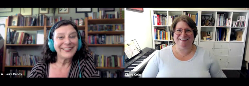 Two white women on a Zoom interview. The woman on the left has long black hair with green headphones, she wears a striped black and grey top. The woman on the left has brown short hair, glasses and black headphones, she wears a blue top. Both have backgrounds with bookshelves full of books. They smile.