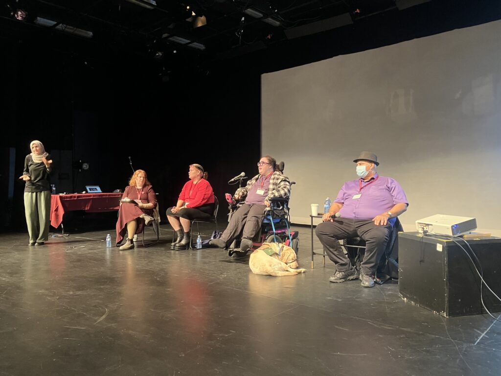 A panel of four artists working in cross-disability collaborations. A sign language interpreter interprets on the left.
